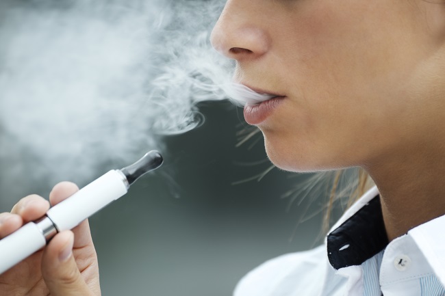 Closeup,Of,Woman,Smoking,E-cigarette,And,Enjoying,Smoke.,Copy,Space